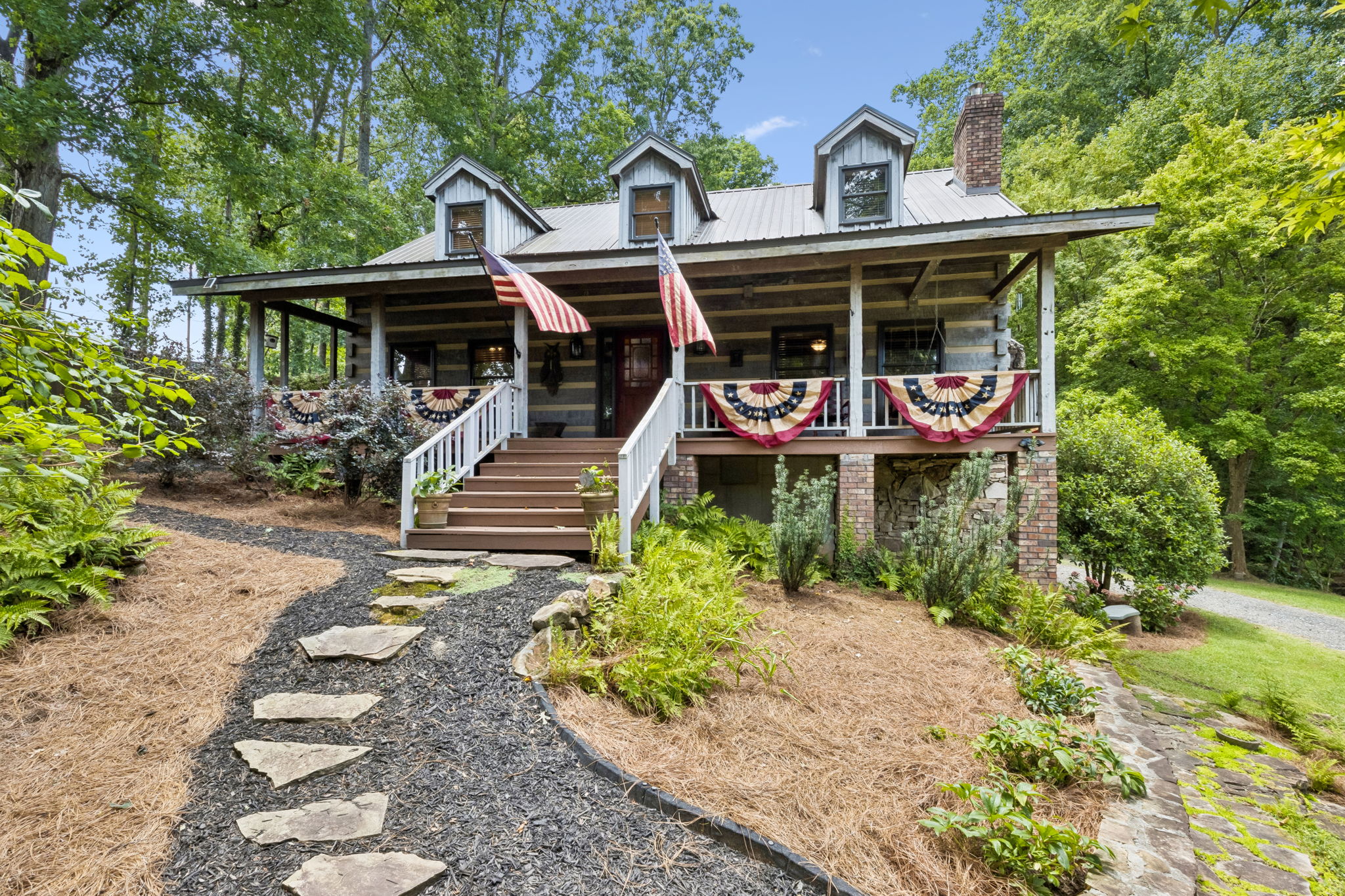 Hearthstone log cabin on 3.6 private acres with a creek-fed pond in Snellville, Georgia.